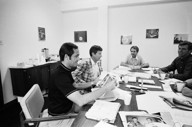 S81-30479 (April 1981) --- Astronauts John W. Young, second from left, and Robert L. Crippen, left, discuss photography from their recent STS-1 mission with astronauts Joe H. Engle, right, and Richard H. Truly during a post-mission debriefing session. Engle and Truly were backup crewmen for STS-1 and they have been named as prime crew members for STS-2, scheduled for a Sept. 30, 1981 liftoff. Photo credit: NASA