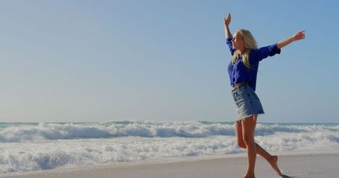 Carefree Woman Enjoying Sandy Beach Under Sunshine - Download Free Stock Images Pikwizard.com