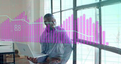 Smiling Professional Analyzing Financial Charts on Laptop