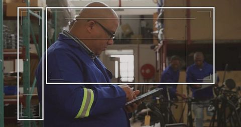 Technician with tablet in bike repair shop