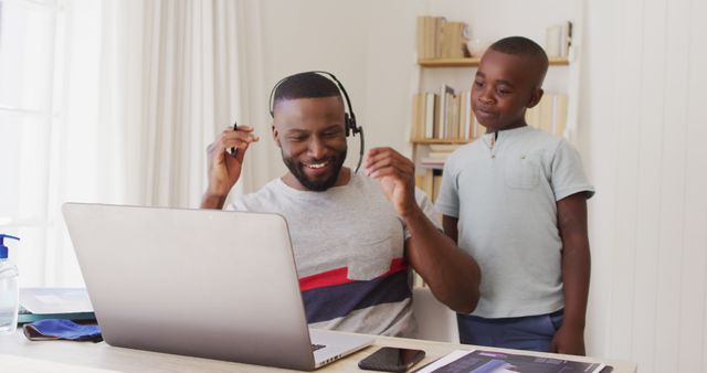 Happy Father Working from Home with Curious Son Watching - Download Free Stock Images Pikwizard.com