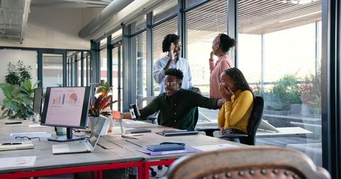 Enthusiastic Team Collaboration in Modern Office Setting