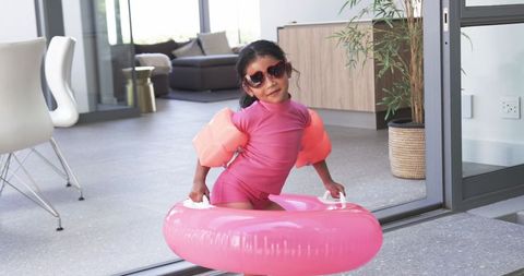 Child Wearing Goggles with Pink Floater Preparing for Pool Activity