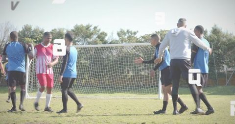 Community soccer team gathering for friendly goal celebration with coach guiding players