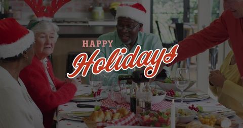 Senior Friends Celebrating Christmas Around Dining Table