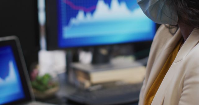 Businesswoman Wearing Mask Analyzing Graphs in Office - Download Free Stock Images Pikwizard.com