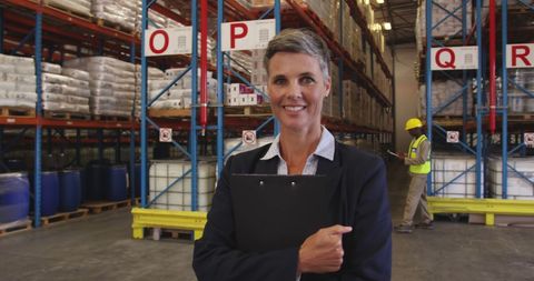 Senior Warehouse Manager Holding Clipboard in Industrial Warehouse - Download Free Stock Images Pikwizard.com