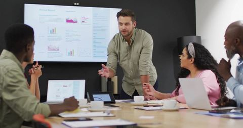 Professional Presenting Key Data in Office Meeting Room