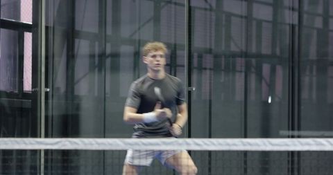 Young Male Athlete Preparing Shot on Padel Court