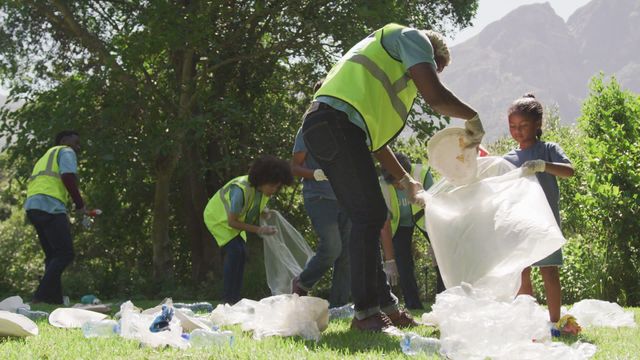 People cleaning a park demonstrate civic responsibility and collaboration. Perfect for materials promoting volunteer initiatives, eco-friendly actions, or community service projects. Highlights environmental awareness and collective action.