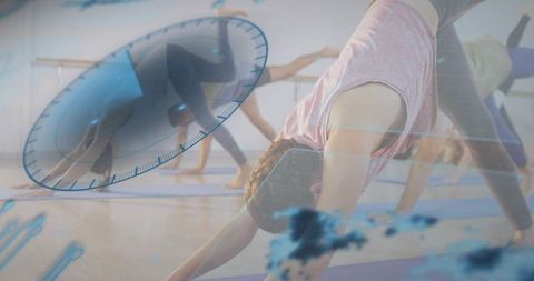 Group yoga practicing downward dog with digital fitness gauge overlay for mindful training