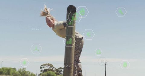 Female Soldier Climbing Pole During Intense Training Session