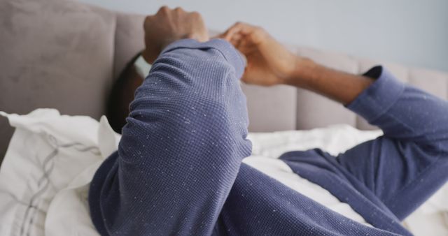 Man Relaxing in Bed with Blue Pajamas - Download Free Stock Photos Pikwizard.com