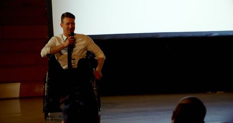 Confident disabled professional speaking at business seminar