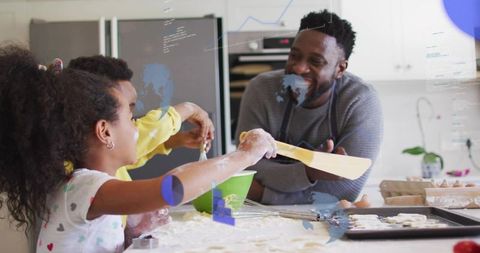 Family baking cookies together in bright kitchen, father smiling while kids mixing dough