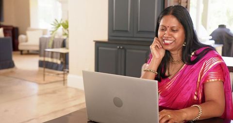 Smiling Woman in Sari Working from Home on Laptop