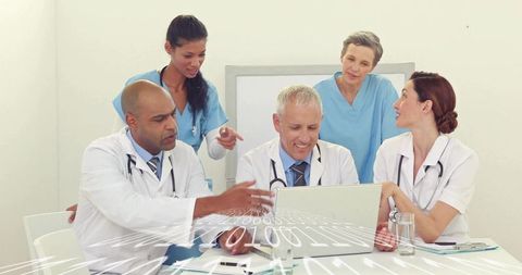 Multidisciplinary medical team collaborating over digital patient data and binary overlay