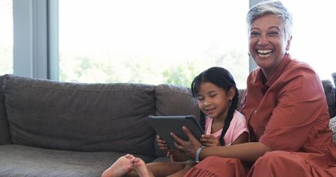 Grandmother and Granddaughter Enjoying Together on Couch