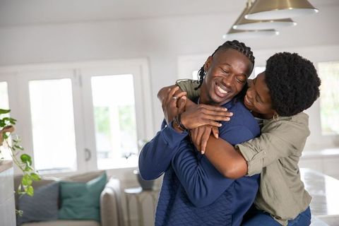 Loving Afro-American Couple Embracing in Modern Home Interior