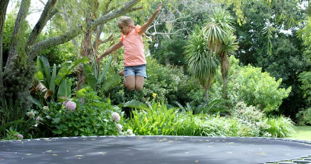 Young Girl Jumping on Trampoline in Lush Garden - Download Free Stock Images Pikwizard.com