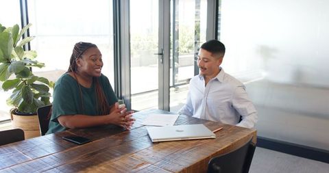 Business Professionals Discussing Contract in Office Meeting