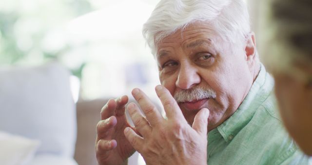 Senior Man in Casual Conversation Indoors - Download Free Stock Images Pikwizard.com