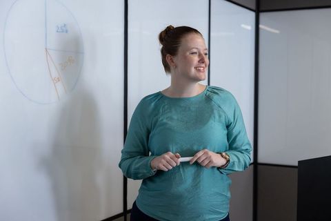 Woman Presenting Data Driven Strategy in Conference Room