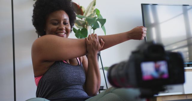 Smiling Woman Stretching Arm in Front of Camera While Exercising at Home - Download Free Stock Images Pikwizard.com