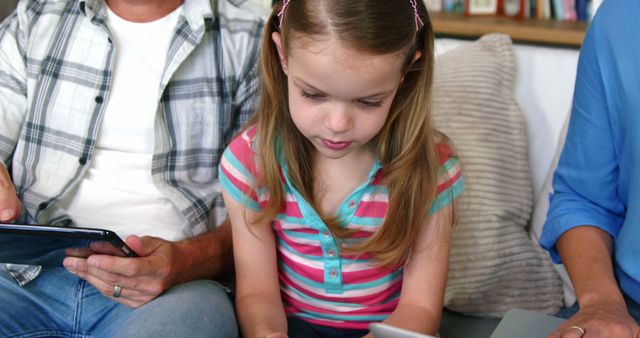 Young Girl Using Tablet with Family at Home - Download Free Stock Photos Pikwizard.com