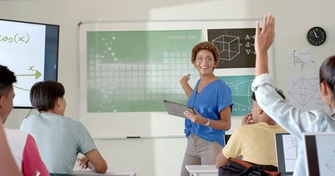 Enthusiastic teacher engaging high school students with interactive learning