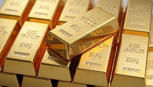 Stacked 300g gold bars reflective bullion closeup embossed gold stamps warm vault light