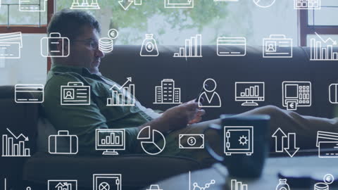 Man Relaxing with Digital Overlay of Business Icons