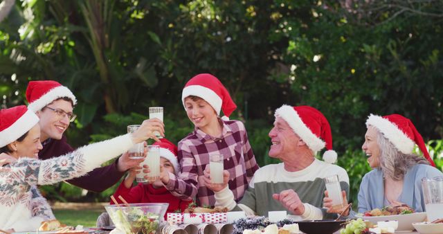 Multigenerational Family Celebrating Christmas Outdoors with Santa Hats - Download Free Stock Photos Pikwizard.com