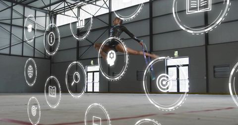 Leaping female rhythmic gymnast performing split jump with ribbon and digital icons overlay