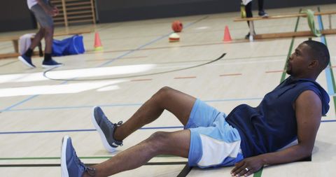Sports Recovery: Athlete Resting on Indoor Basketball Court - Download Free Stock Images Pikwizard.com