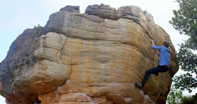 Man Rock Climbing Outdoors On Large Boulder - Download Free Stock Images Pikwizard.com