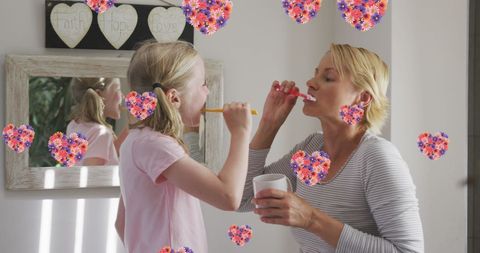 Mother and Daughter Brushing Teeth Surrounded by Hearts and Flowers