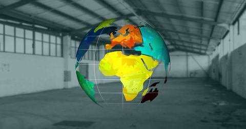 Colorful globes hovering in empty warehouse