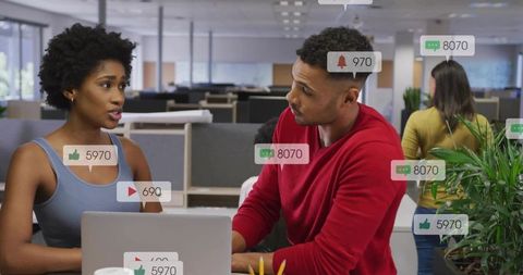 Colleagues Collaborating with Social Media Notifications Overlay in Open-Plan Workspace