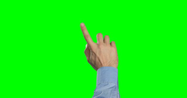Hand of person pointing with index finger in one specific direction against green screen background. Great for isolating hand gestures for visual effects, technology presentations, virtual interfaces, or educational tools.