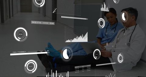 Clinicians reviewing digital health analytics on laptop with futuristic hud in hospital