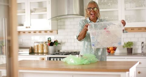 Joyful Senior Woman Engaged in Recycling in Modern Kitchen