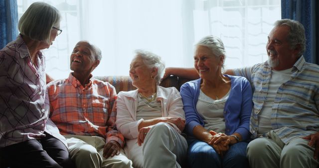 A group of senior Caucasian adults are enjoying a cheerful conversation together, with copy space - Download Free Stock Photos Pikwizard.com