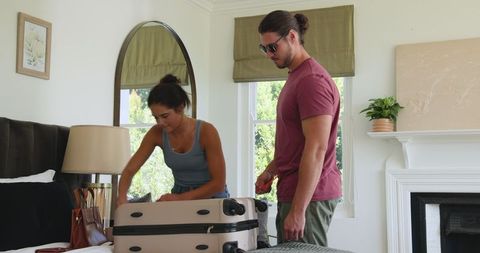 Couple Packing for Vacation with Excitement