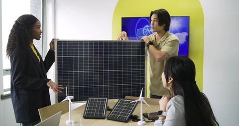 Diverse Team Discussing Green Energy Solutions in Office Meeting