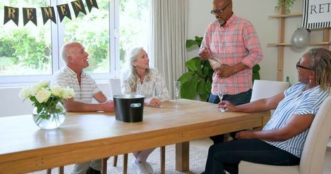 Senior Friends Celebrating Retirement with Champagne