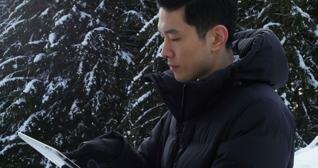 Young Man Using Tablet in Snowy Forest - Download Free Stock Images Pikwizard.com