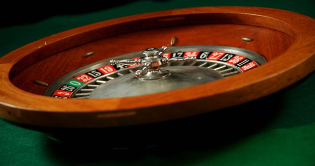 Close-up of spinning roulette wheel on poker table in casino - Download Free Stock Photos Pikwizard.com