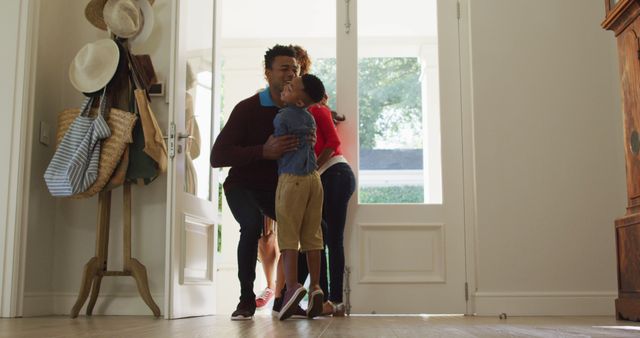 Family members joyfully reunite at home entrance, sharing a warm embrace symbolizing love and togetherness. Ideal for advertising family-oriented products or services, parenting blogs, and campaigns that emphasize familial bonds and welcoming atmospheres.