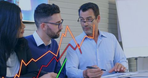 Business Meeting Discussing Data Trends with Graph Overlay